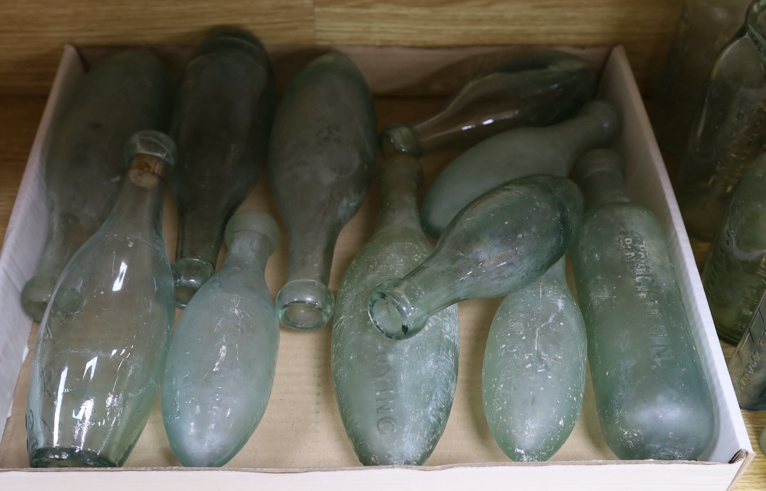 A quantity of early to mid 20th century glass bottles